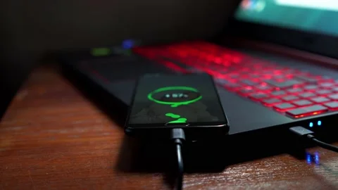 Mobile technology devices can be charged from the notebook. Stock Footage 136750504