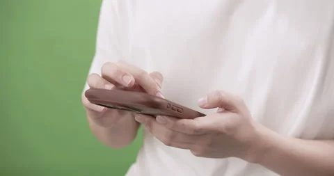 Mobile technology user engaging with device outdoors lifestyle scene close-up Stock Footage 296427584