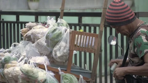 Mobile vegetable seller serving customers and giving change Stock-Footage 241051306