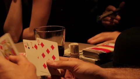 Mobsters gambling and playing cards, drinking, smoking in 1920s/1930s Speakeasy Stock Footage 106947382