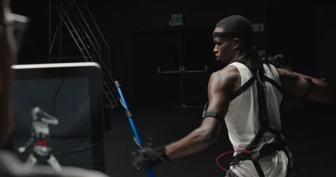 Mocap man wearing motion capture suit in studio using escrima sticks fighting Stock Footage 138391448