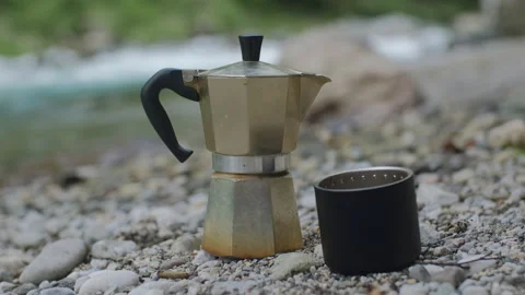Mocha coffee pot on the background of a mountain river in camping Stock Footage 136019055