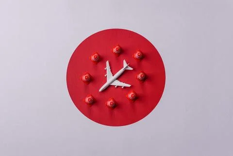 A mock up of airplane surrounded by no fly signs on a japanese flag Stock Photos