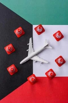 A mock up of airplane surrounded by no fly signs on a Kuwaiti flag Stock Photos