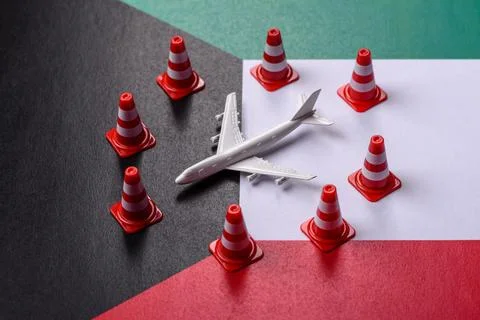 A mock up of airplane surrounded by no fly signs on a Kuwaiti flag Stock Photos