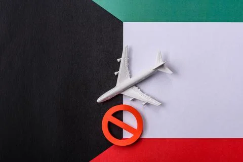 A mock up of airplane surrounded by no fly signs on a Kuwaiti flag Stock Photos
