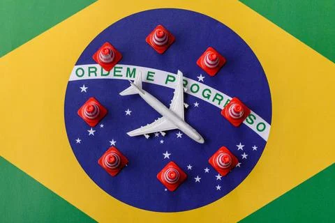 A mock up of airplane surrounded by no fly signs on a brazil flag as a concep Stock Photos