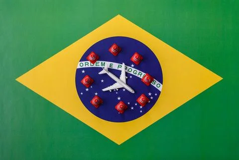 A mock up of airplane surrounded by no fly signs on a brazil flag as a concep Stock Photos