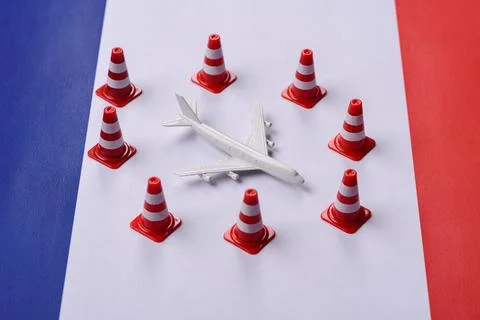 A mock up of airplane surrounded by no fly signs on a French flag Stock Photos