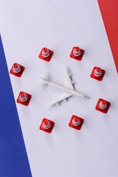 A mock up of airplane surrounded by no fly signs on a French flag Stock Photos