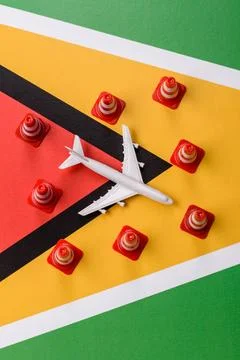 A mock up of airplane surrounded by no fly signs on a Guyana flag Stock Photos