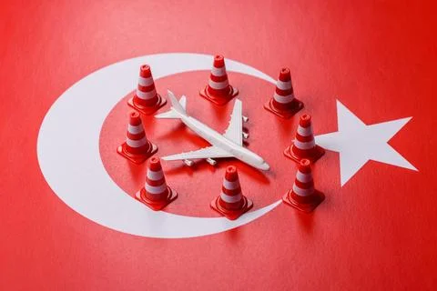 A mock up of airplane surrounded by no fly signs on a Turkish flag Stock Photos