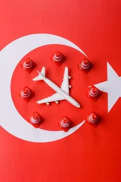 A mock up of airplane surrounded by no fly signs on a Turkish flag Stock Photos