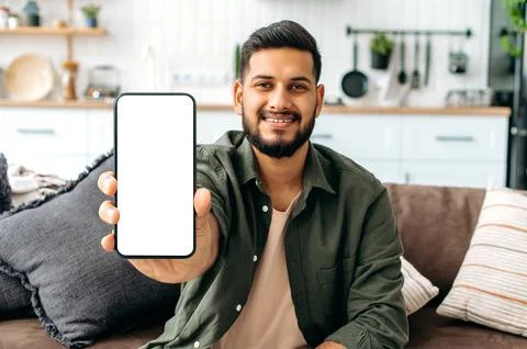 Mock-up and copy-space concept. Positive indian or arabian guy in casual wear Stock Photos