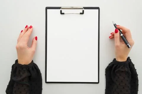 Mock up with blank clipboard with paper document, report. Beautiful female hands Stock Photos