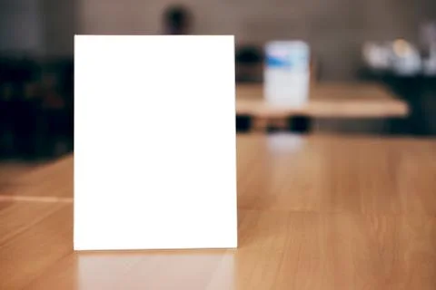 Mock up blank menu frame on table in coffee shop stand for your text of displ Stock Photos