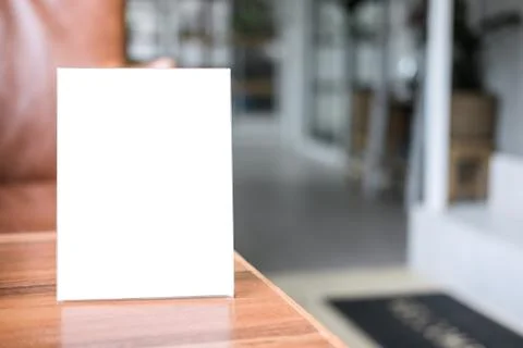 Mock up blank menu frame on table in coffee shop stand for your text of displ Stock Photos