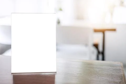 Mock up blank menu frame on table in coffee shop stand for your text of displ Stock Photos