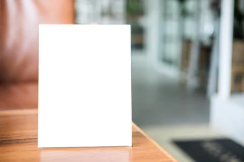 Mock up blank menu frame on table in coffee shop stand for your text of displ Stock Photos