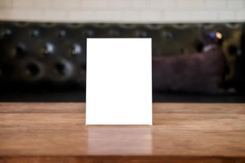 Mock up blank menu frame on table in coffee shop stand for your text of displ Stock Photos