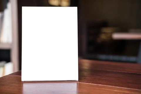 Mock up blank menu frame on table in coffee shop stand for your text of dis.. Stock Photos