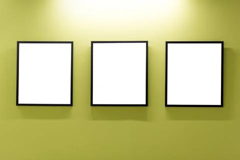 Mock up. Blank picture frames on yellow wall. Gallery wall with empty frames  Stock Photos