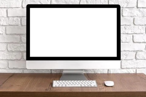 Mock up blank screen computer desktop with keyboard and mouse on wooden table Stock Photos