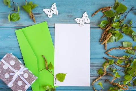 Mock up blank of a spring blank with birch branches on an aged blue backgroun Stock Photos