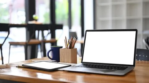 Mock up computer laptop with empty screen and digital tablet on wooden tale a Foto stock