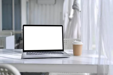 Mock up computer laptop with empty screen on white table in comfortable Stock Photos