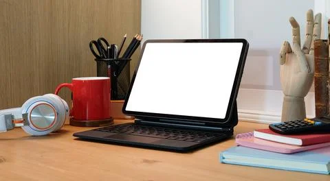Mock up computer tablet with white display, red coffee cup and books on woode Stock Photos