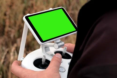 Mock up. Control panel with green screen in male hands. The concept of survei Stock Photos