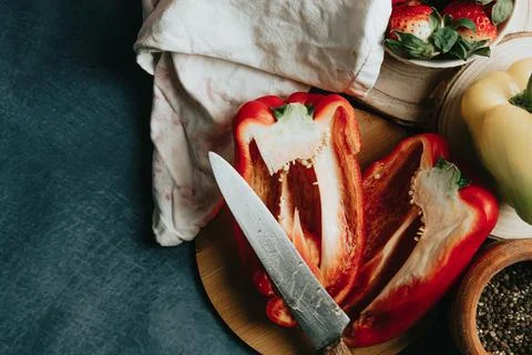 Mock up of a cooking table with a pepper cut in half a knife and some condi.. Фото
