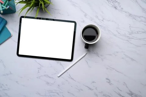 Mock up digital tablet with empty screen, stylus pen, coffee cup and copy spa Stock Photos