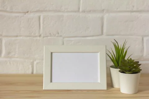 Mock up empty photo frame on table or shelf with copy space. Stock Photos