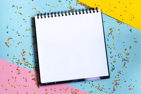 Mock up of empty spiral scketchbook with white paper on bright vibrant Stock Photos