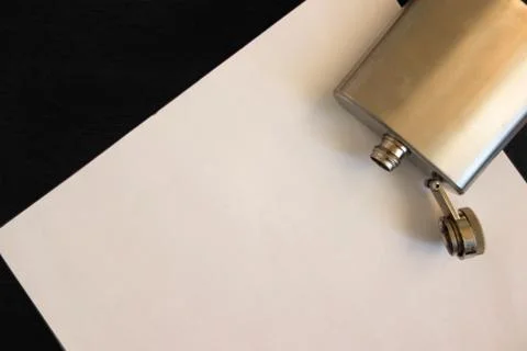 Mock up flat lay of empty sheet of paper and open empty flask on the table. P 스톡 사진