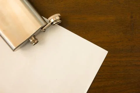 Mock up flat lay of empty sheet of paper and open empty flask on the table. P Stock Photos