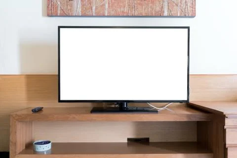 Mock up flat tv screen with remote panel on wwden shelf in living room at hom Stock Photos