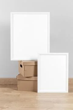 Mock up frames beside cardboard boxes Stock Photos