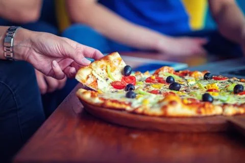 Mock up freelancer workplace. Tablet PC, cell phone and pizza. Top view image Stock Photos