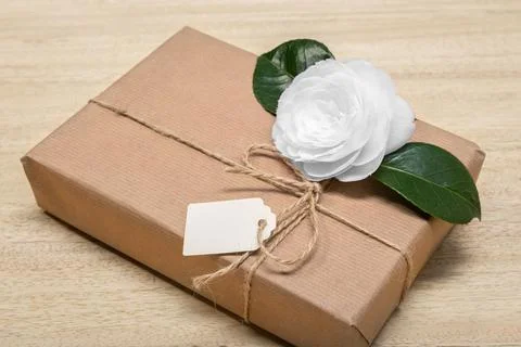Mock up Gift box with blank label and flower. Celebration or present concept Stock Photos