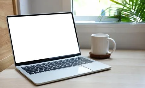 Mock up laptop computer, coffee cup and notebook on wood table... Stock Photos