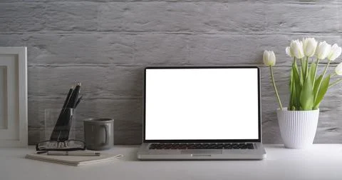 Mock up laptop computer, coffee cup, stationery, picture frame and flower pot Stock Photos