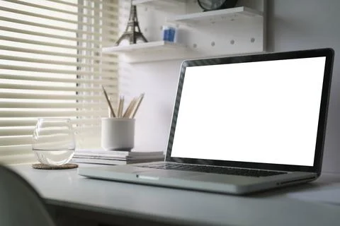 Mock up laptop computer, coffee cup and potted plant on white table. Empty .. Stock Photos