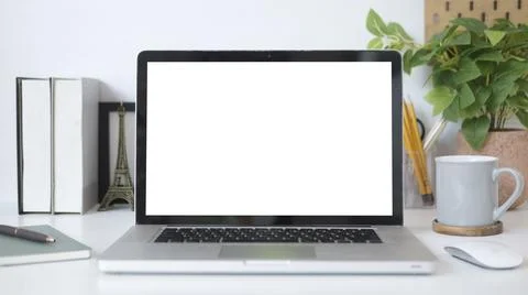 Mock up laptop computer, coffee cup houseplant and stationery on white tabl.. Stock Photos