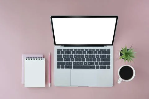 Mock up laptop computer with empty screen, notepad and coffee cup on pink Stock Photos