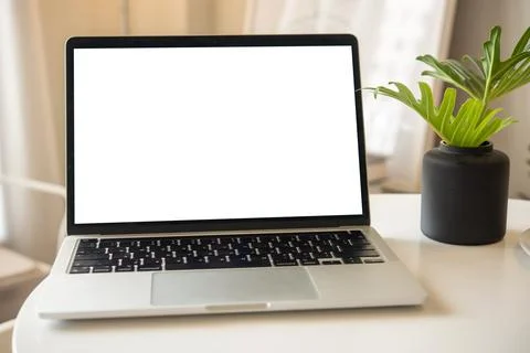 Mock up laptop computer with white screen on table. Stock Photos