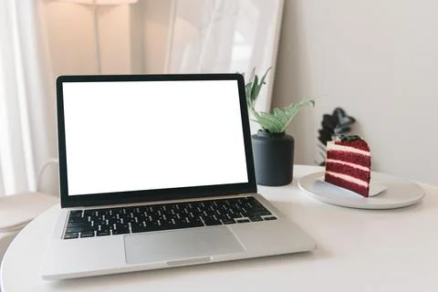 Mock up laptop computer with white screen on table. Stock Photos