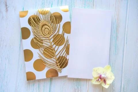 Mock up letter with notepad and orchid flower on light wooden background. View Stock Photos